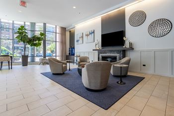 a living room with chairs and a fireplace and a television